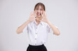 Asian woman in university student uniform with open mouths raising hands shouting good news isolated on white background.