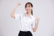 Pretty Asian woman in university student uniform dancing over isolated white background.