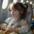 A young girl is sitting in a plane seat with a toy airplane in her hand