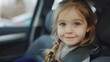 A young girl is sitting in a car seat with her hair in a braid