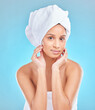 Beauty, towel and portrait of Indian woman with natural facial shine with dermatology cosmetics in studio. Skincare, blue background and clean face of girl model with healthy glow results or wellness