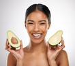 Skincare, portrait and woman with avocado in studio for healthy skin, wellness and nutrition. Female model, face and organic fruit by white background for moisture, cosmetics and glowing tone of girl