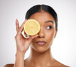 Skincare, face or woman with lemon eye in studio for wellness, glow and organic dermatology on white background. Fruit, beauty or model with sustainable citrus cosmetic, vegan or eco friendly product
