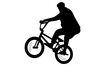 silhouette of man showing off freestyle trick with bicycle