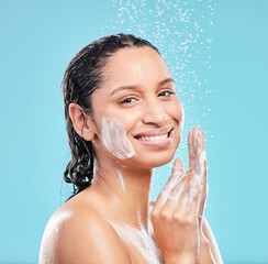 Poster - Shower, cleaning and portrait of happy woman for skincare, hygiene or wellness isolated on blue studio background. Water splash, soap bath and face of model for dermatology, health or wash for beauty