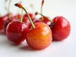 A group of cherries with water droplets on them.