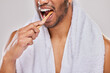 © peopleimages.com - Man, bamboo tooth brush and teeth whitening in studio for healthcare, wellness and smile by backdrop. Male person, hand and dental for bad breath, mouth and sustainable product for cleaning