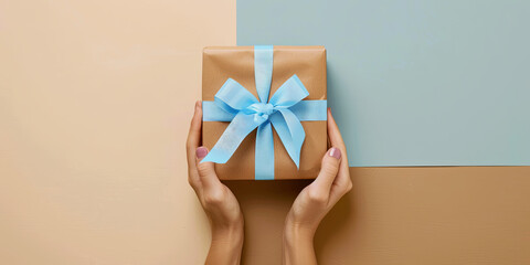 Wall Mural - female hands holding gift box with blue ribbon on pastel background, generative AI