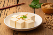 Fresh Sliced Soft Tofu soy bean curd on white plate