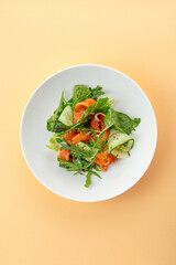 Sticker - salad with salmon, vegetables and sauce