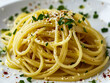 A plate of spaghetti with parsley and parmesan cheese.