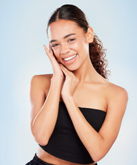 Poster - Portrait, skincare and happy woman in makeup for glow, shine or health isolated on blue studio background. Face, touch and beauty of model in cosmetics for dermatology, wellness and body aesthetic