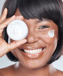 Happy, portrait and black woman with cream container for skincare or moisturizer on a white studio background. Face of African, female person or model with smile and lotion for facial or dermatology