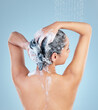 Woman, shower and hair for shampoo in studio with back for cleaning, growth and dandruff by blue background. Girl, person and model with water drops for product, soap and foam with scalp wellness