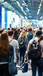 © fotogurmespb - Dynamic bustling crowd of people walking around a convention hall at a tech conference or expo