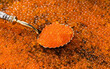 Red Caviar in a spoon. Caviar background. Fish roe, Close-up salmon or trout caviar. Delicatessen. Gourmet food. Texture of caviar. Seafood 