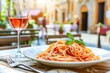 Sumptuous Plate of Spaghetti With Tomato Sauce and Basil in a Sunny Italian Street Café