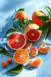 Fresh Citrus Fruits on a Blue Background With Highlighted Grapefruit