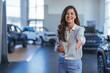 Car dealer woman. Auto dealership and rental concept background. Professional female salesperson at car dealership. Picture of professional salesperson working in car dealership