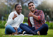Portrait, students and friends with thumbs up, grass or relax with education, icon or promotion for university. Face, smile and man with woman in park, hand gesture or like with symbol, agree or sign