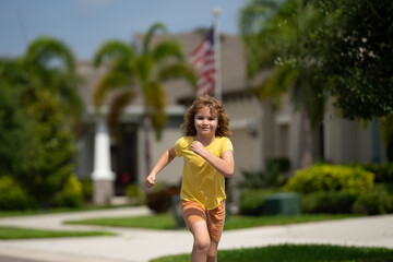 Sticker - Cute kid boy running across american neighborhood street. Summer, childhood, leisure and people concept. Happy little blonde child boy running in summer park outdoor. Sport and run.