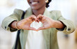 © peopleimages.com - Black woman, business and hands with heart in office for gratitude, support and compassion for company goal. African female employee, corporate and love emoji or icon for kindness, hope and empathy