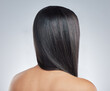 Back, hair care and woman with beauty, shine and wellness with dermatology on white studio background. Rear view, person and model with glow, texture and volume with keratin, luxury and aesthetic