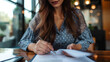 © Alex Alex - Cropped image of a business woman signing a contract.