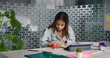 © Raushan_films - Indian Asian young adult gen z upset stress busy woman lady sitting use tablet touch pad do day task work job office Teen age female girl expert staff pay fees check tax loan loss count rent bills
