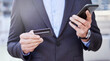 © peopleimages.com - Businessman, credit card and hands in city with smartphone for online shopping, mobile banking and expense tracking. Man, corporate and details or password for payment, subscription service and sale.