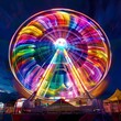 Rainbow Ferris Wheel in Carnival Fairground at Night A Vibrant Spin of Colors and Joy