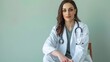 © Don Media - A seasoned female physician in a white coat is sitting cross-legged on a chair, looking directly at the camera