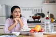 © WESTOCK - Indian woman on dining table waiting for husband or child after preparing food at home for lunch - concept of family caring, responsibility and patience