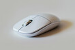 © KirKam - Sleek white wireless computer mouse isolated on a light grey background, highlighting its modern and minimalistic design.