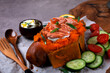 Baked sweet potato stuffed with hot smoked trout, sour cream sauce and topped with green onion