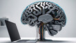 A electronic metal human brain with wires attached connected to a laptop computer