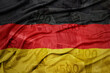 waving colorful national flag of germany on a euro money banknotes background. finance concept.