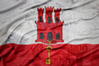 waving colorful national flag of gibraltar on a euro money banknotes background. finance concept.