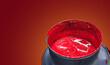 © ismailgazel - Red printing paint in a metal bucket. Industrial offset printing ink. Blank writing space on red background. CMYK cans of paint.