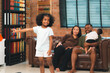 © chokniti - Happy African American Family at Home: Mother and Father Hug Their Young Daughter and Son, Sharing Love and Fun Together, Portraying Cheerful Moments of a Black American Household
