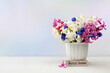 Beautiful spring flowers hyacinths and muscari in a vase on a light background, flyer.Abstract floral composition, still life with space for text, floral holiday card, summer greeting concept,