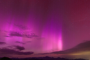beautiful violet pink red aurora borealis the northern lights over the horizon in slovenia.