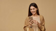 Smiling Young Woman Enjoying Online Shopping with Mobile Phone
