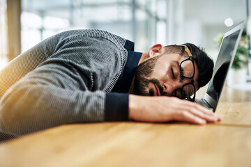 Poster - Businessman, sleeping and tired with laptop by desk for burnout, exhausted or low energy by workspace. Corporate, employee and glasses with nap in office for work deadline or overwhelmed with project