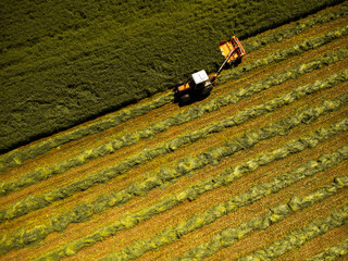 Agricultural field witn tractor aerial drone view in springtime