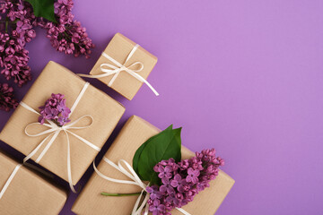 Wall Mural - Set of brown craft gift boxes with lilac flowers and violet ribbons. Horizontal, space for your text.