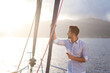 Man traveling on yacht at sea and drinking wine. Sailing trip, solo summer vacation at sunset. Traveler relaxing, enjoying holidays in self isolation, looking at beautiful view, nature, landscape