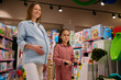 Happy family shopping time concept with pregnant mother and daughter