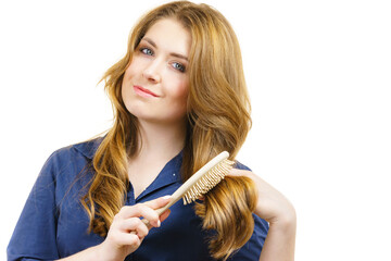 Canvas Print - Woman brushing long healthy brown hair