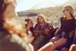 © Marko Geber - Young friends enjoying music and road trip with guitar in pickup truck